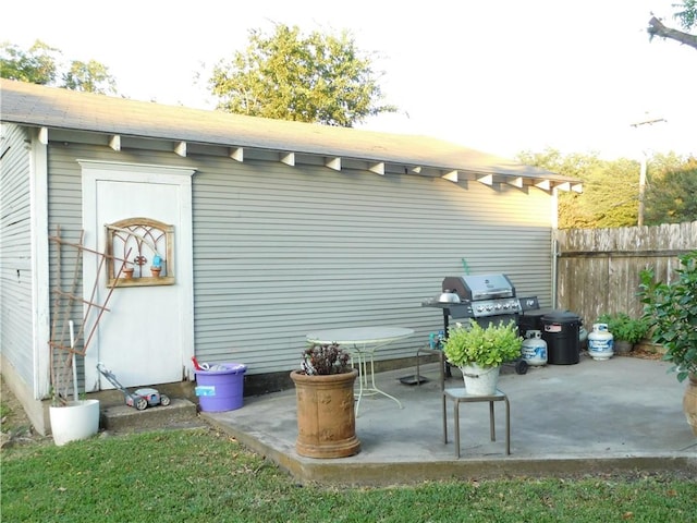 view of patio / terrace featuring an outdoor structure and a grill