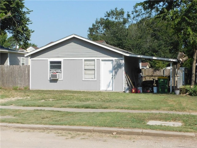 view of side of home with a lawn and cooling unit