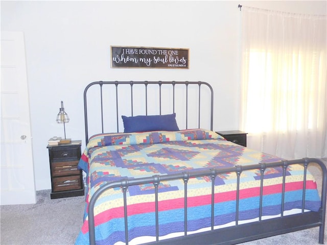 bedroom featuring light carpet