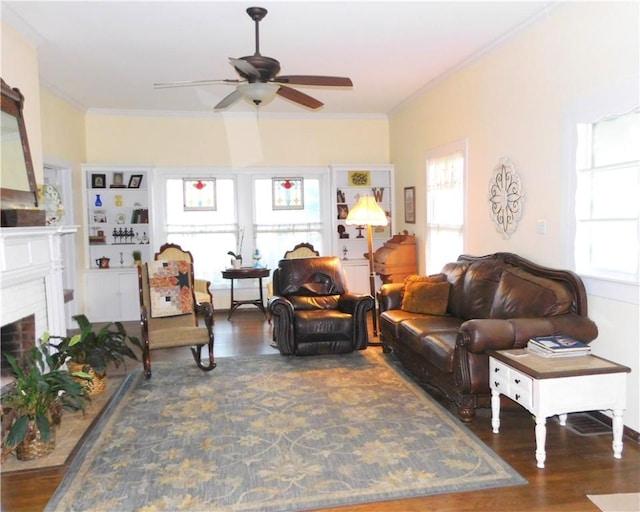 living room with dark hardwood / wood-style floors, ceiling fan, and crown molding