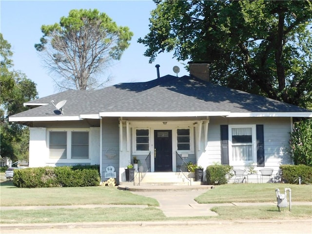 bungalow-style house with a front lawn