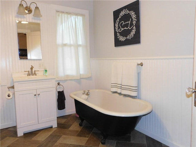 bathroom featuring vanity and a tub to relax in