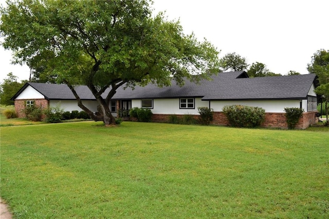 ranch-style house with a front lawn