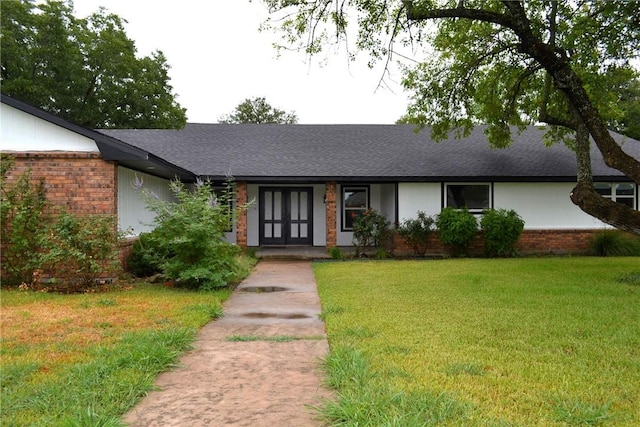 view of front of home featuring french doors and a front yard