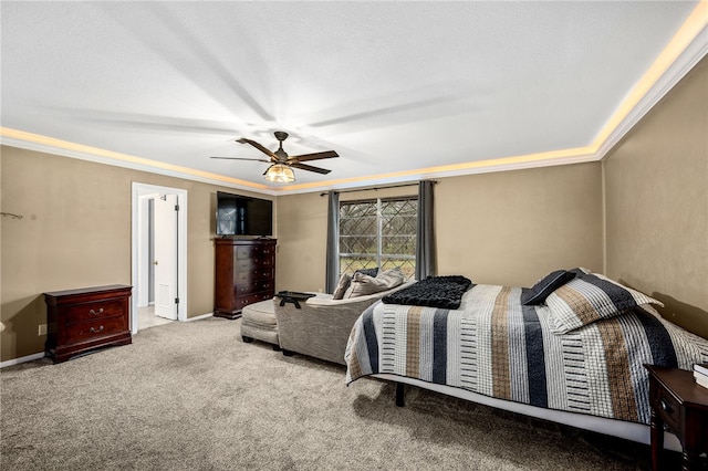 carpeted bedroom featuring ceiling fan, ornamental molding, and a textured ceiling