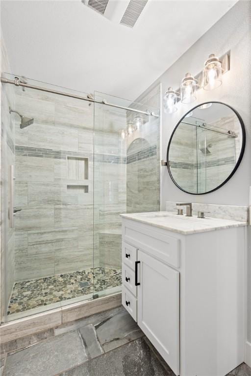 bathroom featuring vanity and an enclosed shower