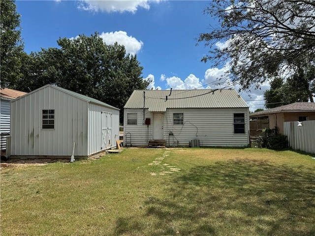 rear view of property with a yard