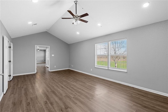 unfurnished bedroom featuring a walk in closet, ceiling fan, dark hardwood / wood-style floors, and lofted ceiling