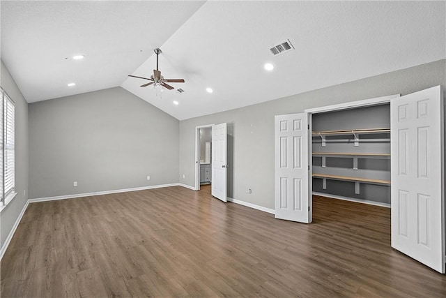 unfurnished bedroom with dark hardwood / wood-style floors and lofted ceiling