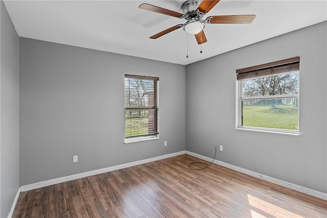 empty room featuring ceiling fan and light hardwood / wood-style floors