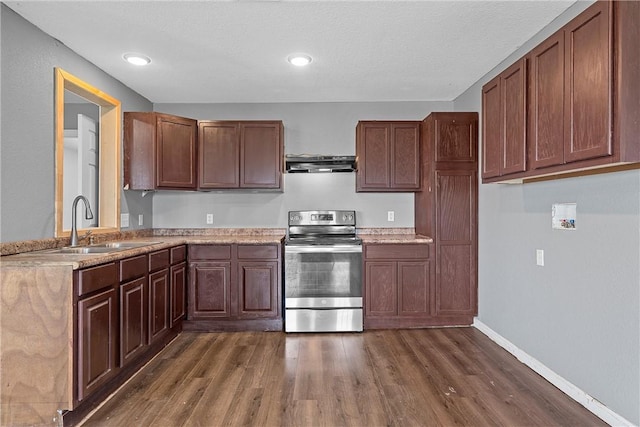 kitchen featuring electric stove, sink, dark wood-type flooring, and range hood