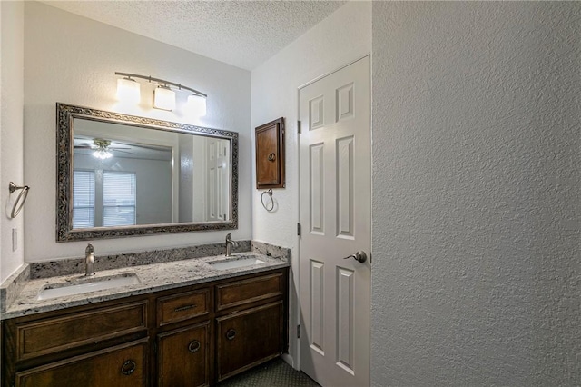 bathroom featuring vanity and a textured ceiling