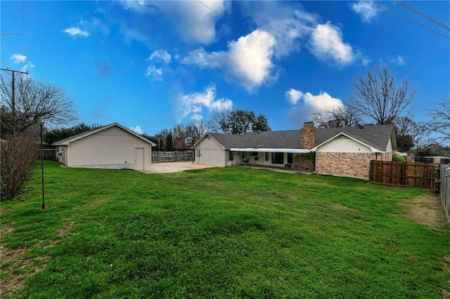 back of property featuring a yard and a patio