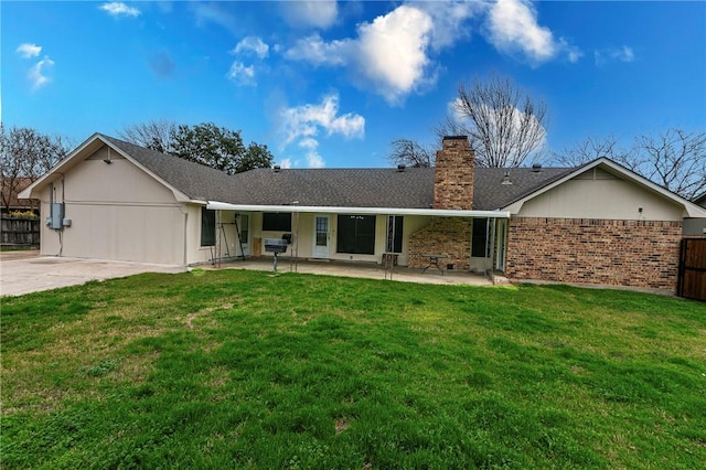 rear view of house featuring a yard and a patio area