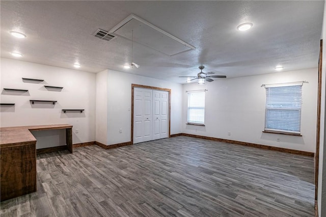 interior space featuring hardwood / wood-style floors, a textured ceiling, and ceiling fan