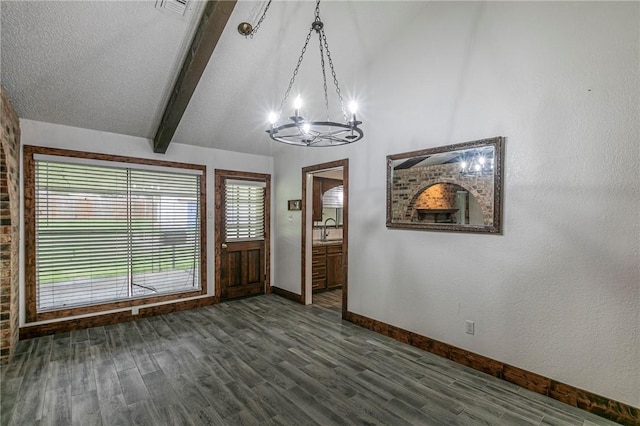 foyer featuring an inviting chandelier, vaulted ceiling with beams, sink, and dark hardwood / wood-style floors