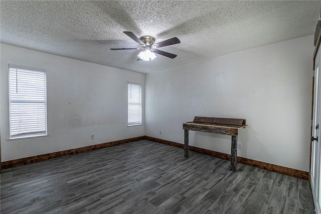 unfurnished room with dark wood-type flooring, a textured ceiling, and ceiling fan