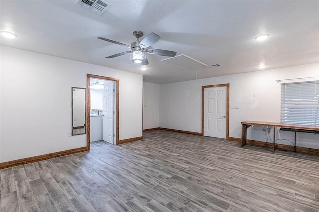 empty room with ceiling fan and light hardwood / wood-style flooring