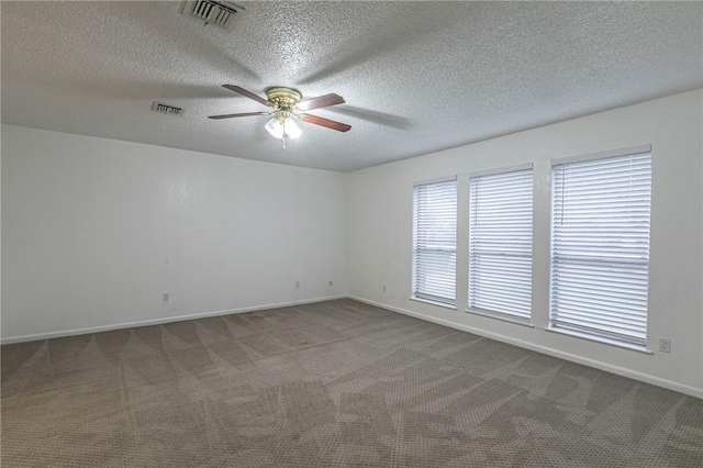 spare room featuring carpet flooring, a textured ceiling, and ceiling fan