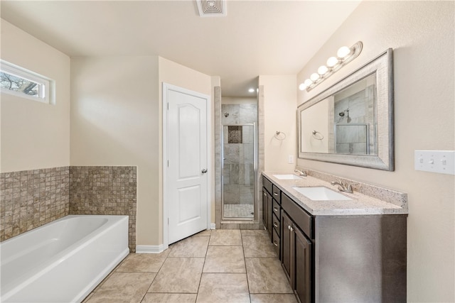 full bathroom with visible vents, a shower stall, and a sink