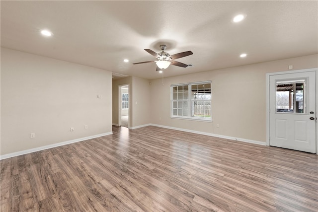 empty room with recessed lighting, baseboards, and light wood finished floors