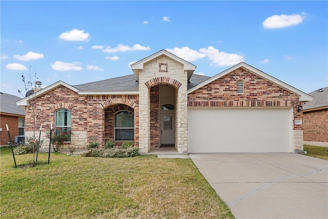 view of front of property featuring a garage and a front yard