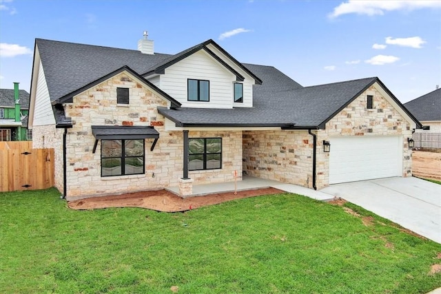 view of front of home featuring a garage and a front yard