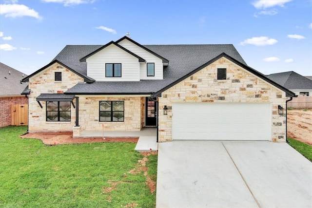 view of front of property with a garage and a front yard