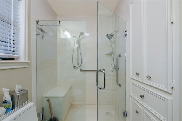 bathroom with a shower with door