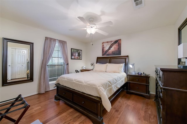 bedroom with ceiling fan and dark hardwood / wood-style flooring