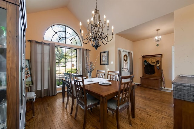 dining space with lofted ceiling, an inviting chandelier, and dark wood-type flooring