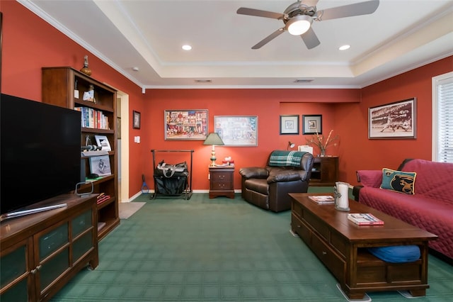 living room with a raised ceiling, crown molding, and carpet floors