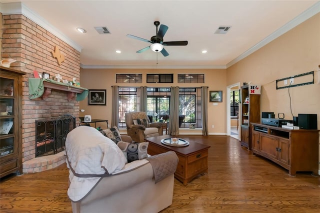 living room with crown molding, a fireplace, ceiling fan, and wood-type flooring