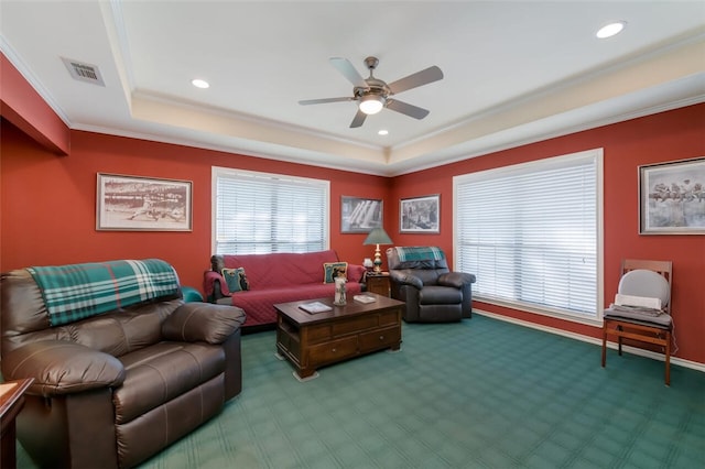 living room with carpet, a tray ceiling, ceiling fan, and crown molding