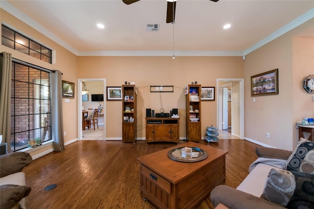 living room with dark hardwood / wood-style floors, ceiling fan, and crown molding