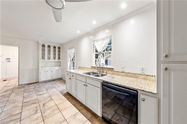 kitchen featuring white cabinetry, sink, light stone countertops, black dishwasher, and crown molding