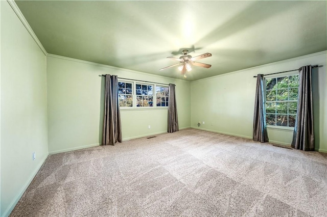 empty room with light carpet, ceiling fan, and ornamental molding