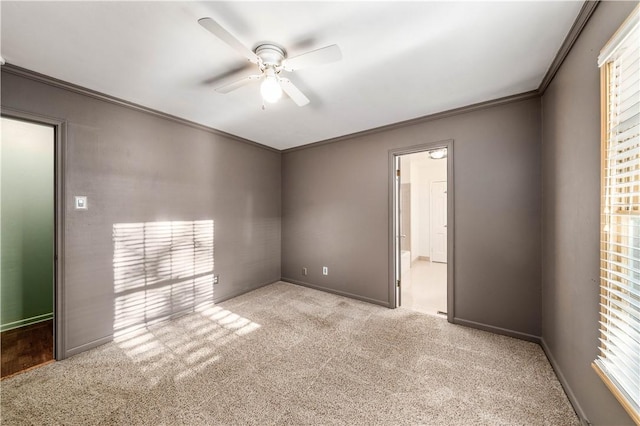 spare room featuring ceiling fan, light colored carpet, and ornamental molding