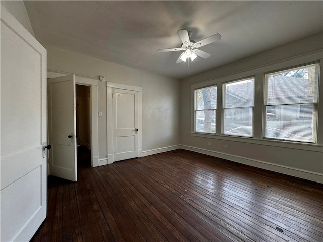 interior space with ceiling fan and dark hardwood / wood-style flooring