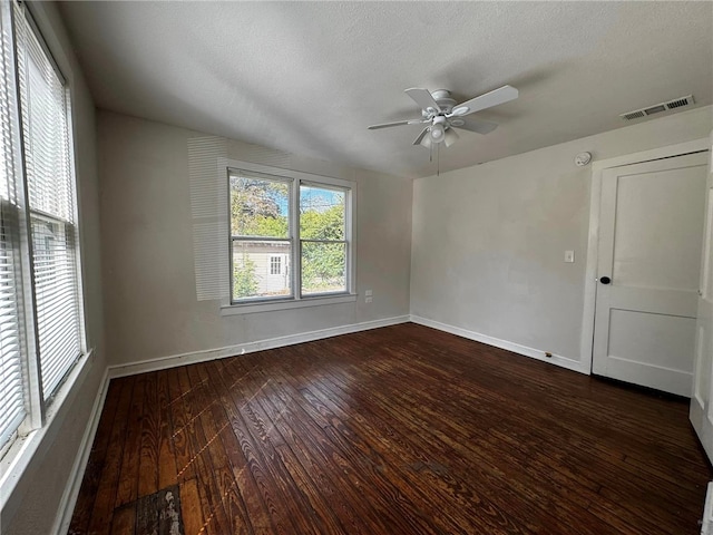 unfurnished room with dark hardwood / wood-style floors, ceiling fan, and a textured ceiling