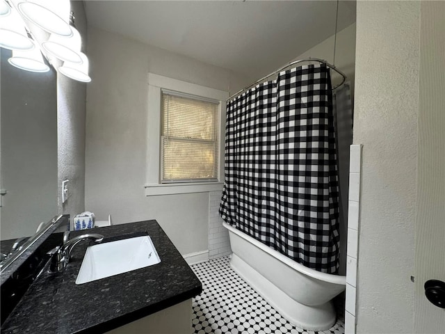 bathroom with tile patterned flooring, vanity, and shower / bath combo