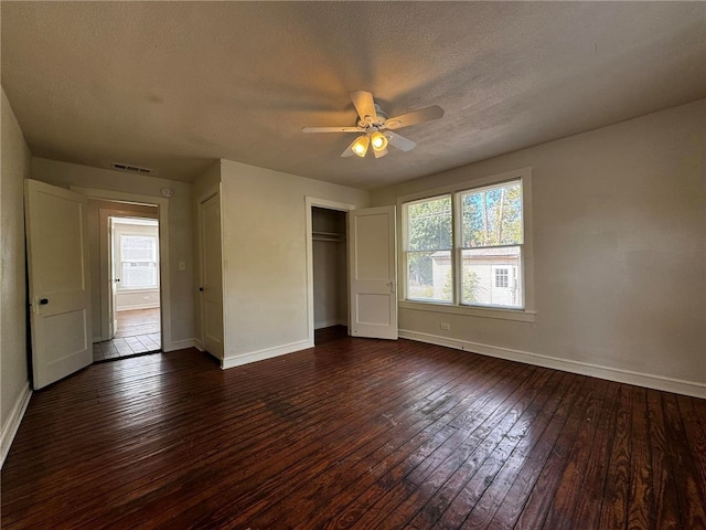 unfurnished bedroom featuring a textured ceiling, dark hardwood / wood-style floors, and ceiling fan