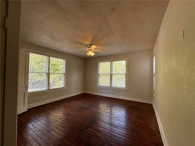 unfurnished room featuring a textured ceiling, ceiling fan, and dark wood-type flooring