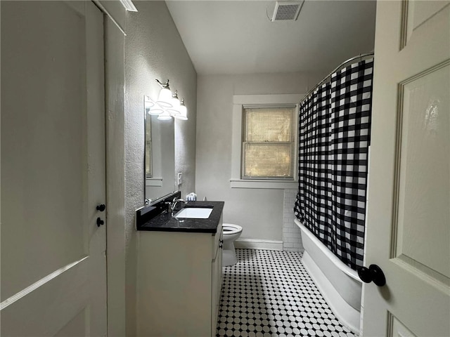 full bathroom with vanity, toilet, and shower / tub combo with curtain