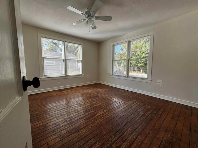 unfurnished room with ceiling fan, dark hardwood / wood-style flooring, and a textured ceiling