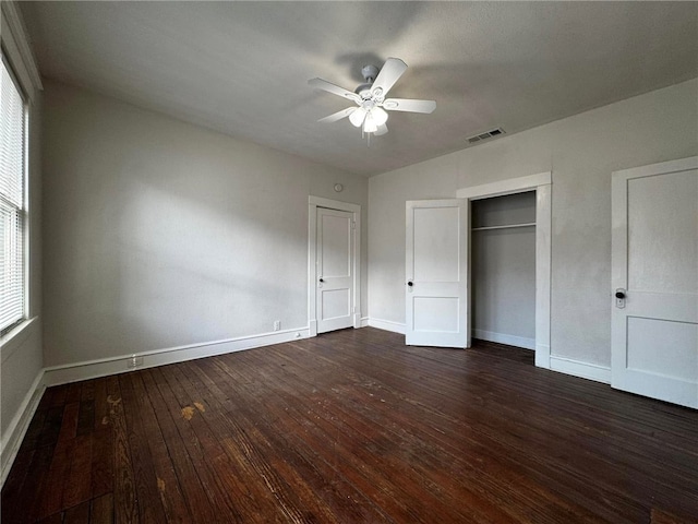 unfurnished bedroom featuring ceiling fan, a closet, and dark hardwood / wood-style floors