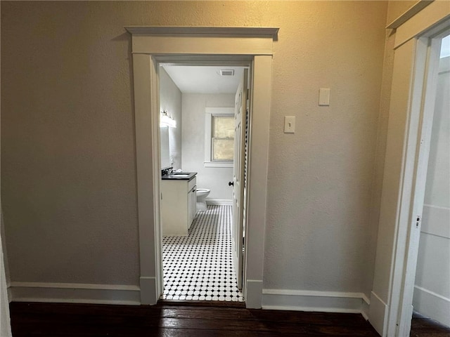 hallway with dark hardwood / wood-style flooring