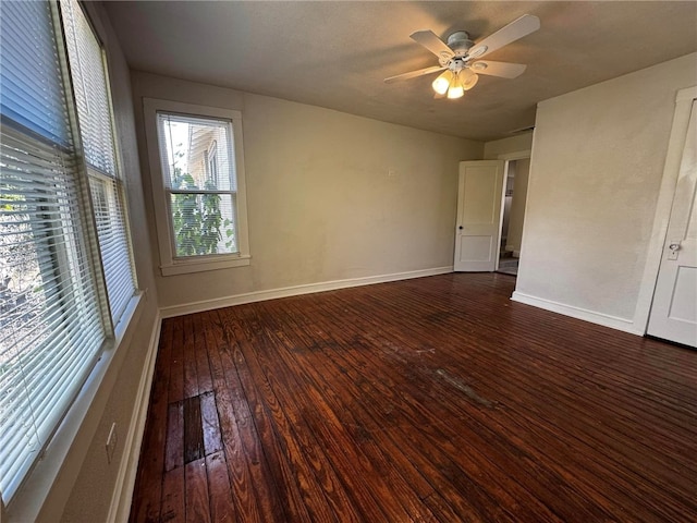 unfurnished room with dark hardwood / wood-style flooring and ceiling fan