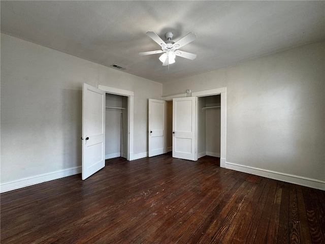 unfurnished bedroom featuring dark hardwood / wood-style floors and ceiling fan