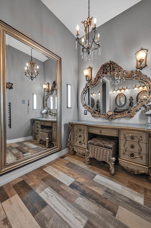 bathroom with hardwood / wood-style flooring and lofted ceiling